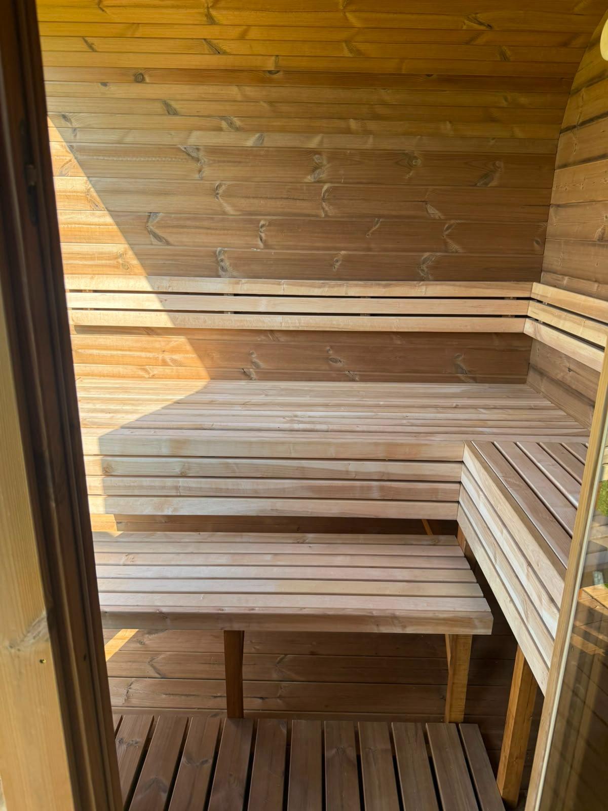 Sauna interior with benches and stove 16